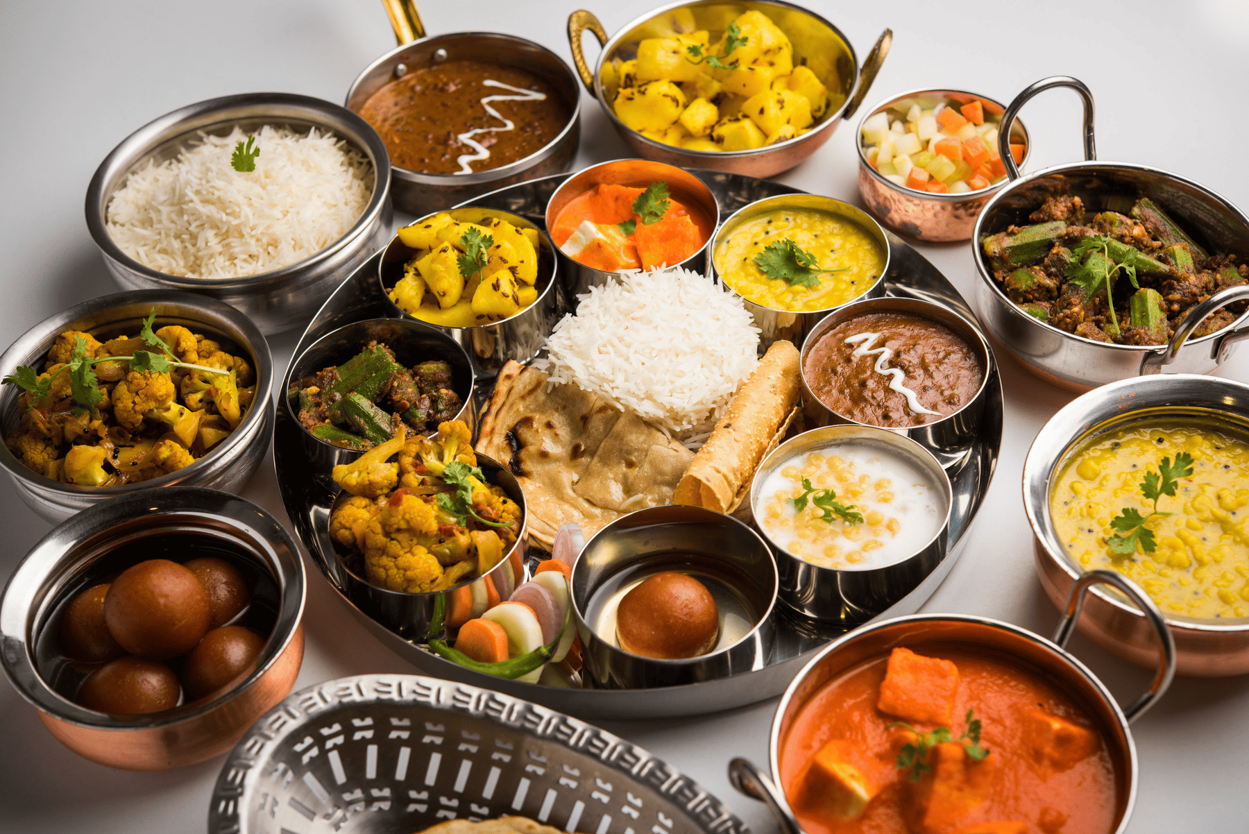 A traditional Indian thali showcasing a variety of vegetarian and non-vegetarian dishes